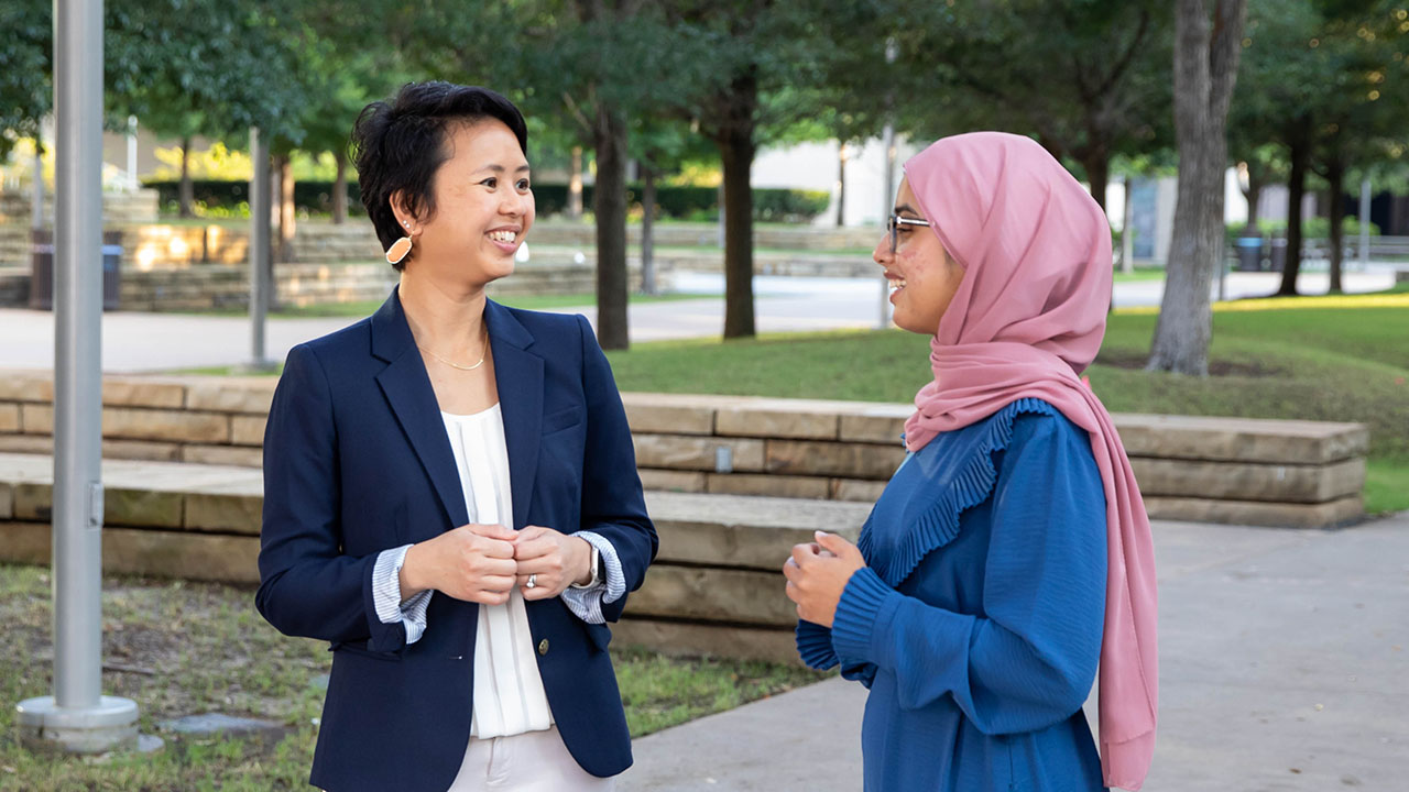 Image of Fern Yoon talking to a colleague