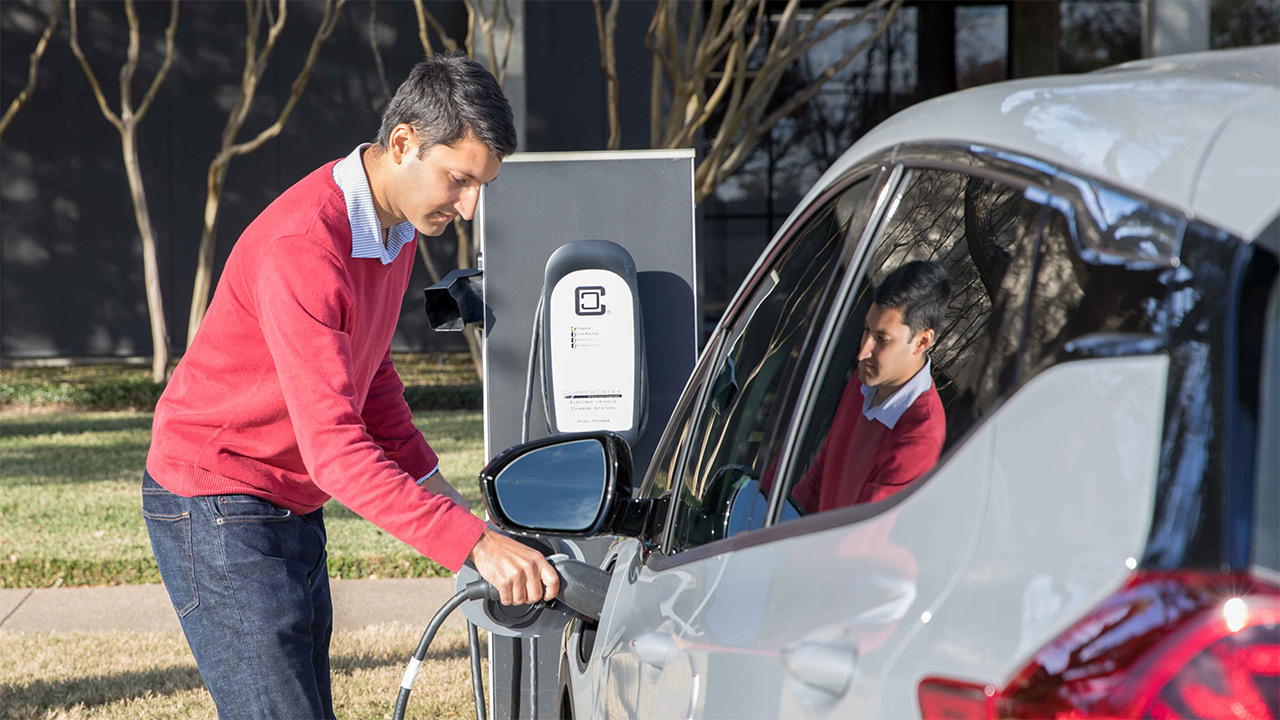 Pradeep charges his electric vehicle.